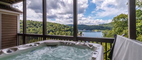 Private deck off of the primary bedroom with hot tub overlooking Lake Glenville