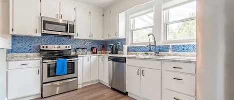 Kitchen is large with brand new Kenmore Stainless Steel Appliances. Kitchen is fully stocked with almost everything you need to cook (pots, pans, dishes, knives, mixers and more). 