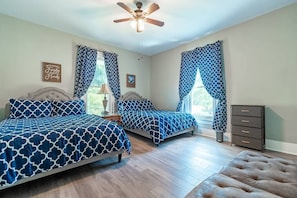 Large Bedroom with 2 brand new Queen size mattresses, comfortable sheets & pillows. Also a futon that sleeps 1 with pillow/sheets. This bedroom can sleep 5 people and living room can sleep 2 for a total of 7.