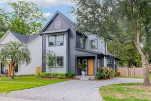 Stylish front of house with a driveway that can easily fit 4+ cars.