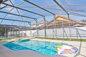 Soak up the sun by the luxury swimming pool in the enclosed backyard.