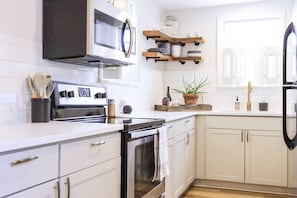 Fresh and clean kitchen with quartz countertops and tile backsplash