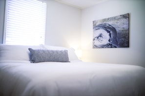 Bedroom with king mattress and personal photography from Yellowstone NP