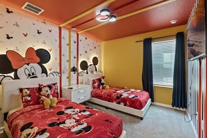 Disney themed bedroom with two twin beds. Mickey and Minnie Mouse.
