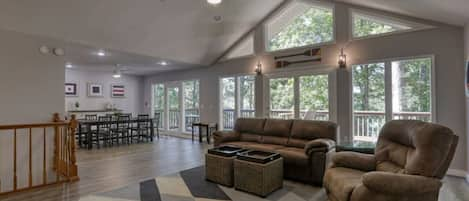 Main Level open Great Room invites you and the sunlight under cathedral ceilings