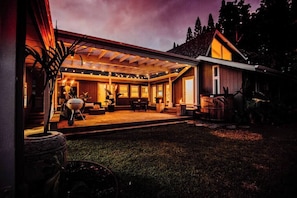 courtyard with BBQ, dining , seating, hot tub, tea lights, tiki torches