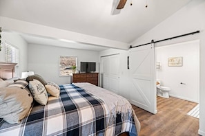 Easy access to the master bath and pass-through closet under vaulted ceilings
