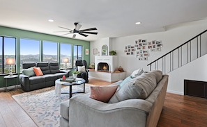 Spacious living room with fireplace, large TV and views. 