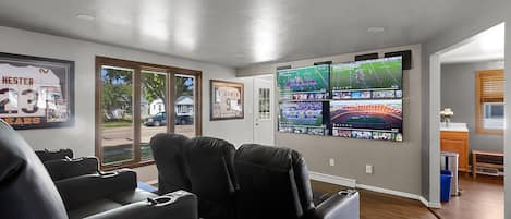 Stadium style living room features 4 TV's for the ultimate game day experience!