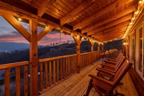 Relax in rocker chairs as the sun sets over the mountains, providing a perfect end to your day