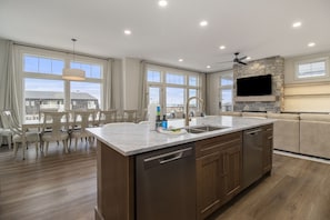 2nd floor the main kitchen island with 6 bar stools.