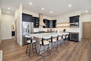 2nd floor the main kitchen island with 6 bar stools.