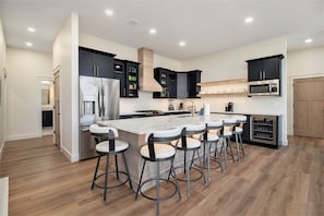 2nd floor the main kitchen island with 6 bar stools. 