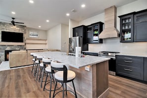 2nd floor the main kitchen island with 6 bar stools.