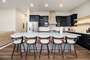 2nd floor the main kitchen island with 6 bar stools.