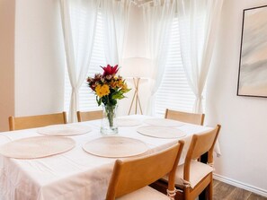 6 seater table with beautiful few of the back yard. You can also see whats happening in the kitchen and living room while you eat. 
