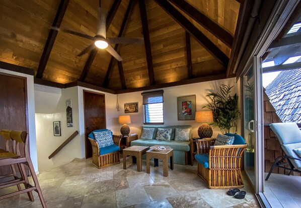 Spacious living area with open beam ceiling.