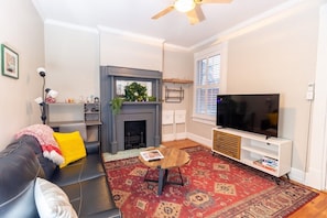 Living room has office area and historic fireplace ready for holidays 