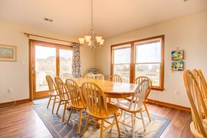 There is seating at the bar for 4 and the adjoining dining area features a large table with seating for 10 and a water view.