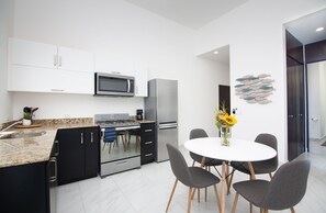Well equipped kitchen and dining area. Laundry is in the hallway 