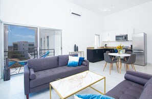 Living room, great kitchen and terrace seating on rocking acapulco chairs