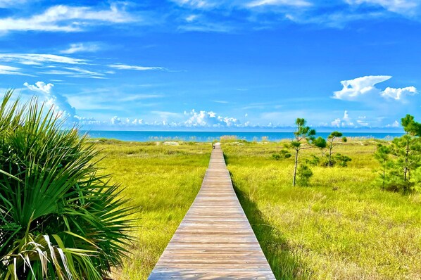 Just steps from the front door this boardwalk leads you to the white sand beach!