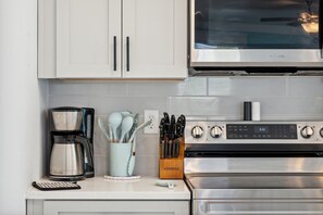 Crisp and clean stainless steel appliances complete this well appointed kitchen.