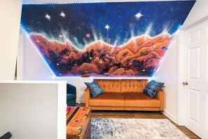 The coolest mural surrounds you in the living room