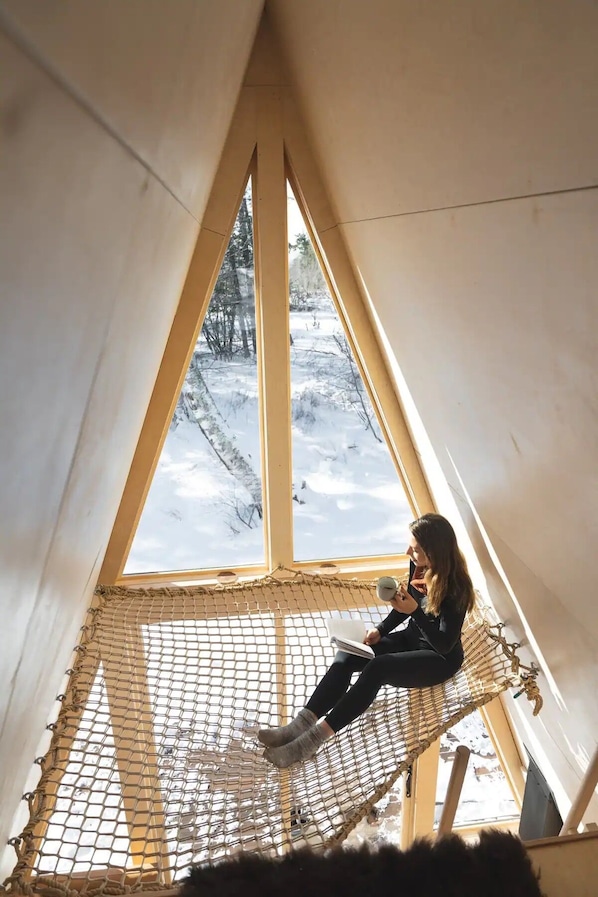 Float among the stars and aurora gaze in the hanging loft net.