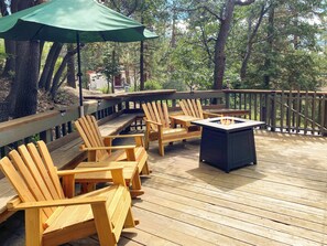 Spacious deck with comfortable seating and a firepit.