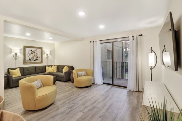 Xanadu A8 - Living Room - Brand new renovated unit!  New furniture and lighting in this living room that comfortably seats 8.  Private balcony overlooking the grounds.