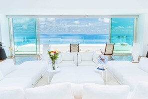 Main living space with comfy sofas, chairs & awe-inspiring scenery