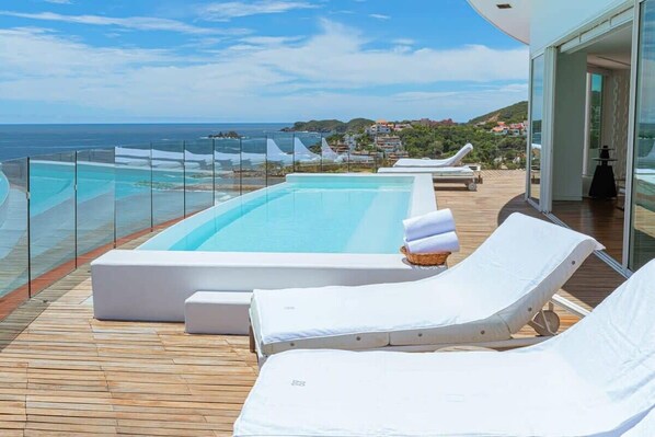 Private terrace w/ pool, cushy lounge chairs & stunning views of the sea