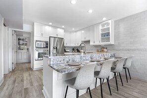 Large kitchen for cooking meals and 4 counter seats in addition to dining table.
