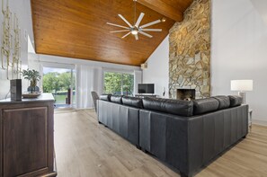 Living Room with panoramic wall of sliding doors out to expansive deck