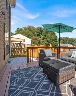 Back deck with outdoor seating and BBQ grill