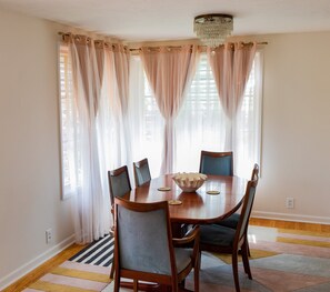 Dining room area and table, large enough for up to six guests.