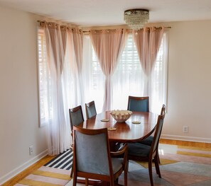 Dining room area and table, large enough for up to six guests.