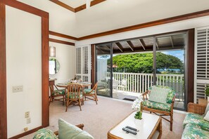 Living room opens to private lanai with overlooking the gardens.