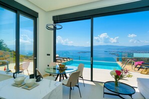 The dominant color scheme is white, creating a sense of airiness and brightness throughout the villa.