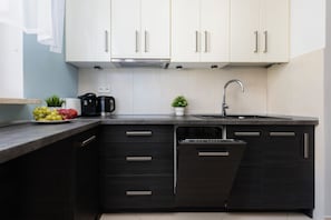 Kitchen with plenty of kitchen utensils and dishes.