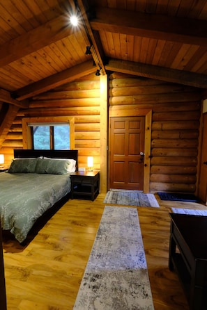 Entrance with high ceilings and log walls.