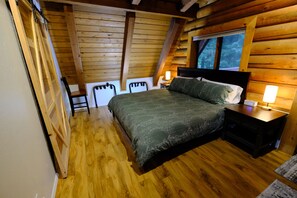 King size bed with lamps and clock.