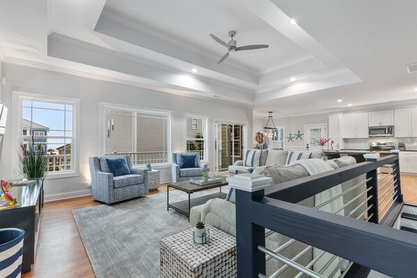 WOW What a View! The open floor plan living room, kitchen and dinign room ensures no one is left out.  Plenty of seating for the family to chat, play board games or even take in the big game!