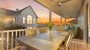 Soaking up the evening sun from the third floor rear deck - full dining table and hang our area.
