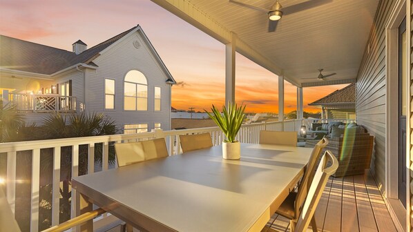 Soaking up the evening sun from the third floor rear deck - full dining table and hang our area.