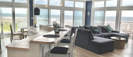 Sweeping ocean views from the living room, dining area, and kitchen.