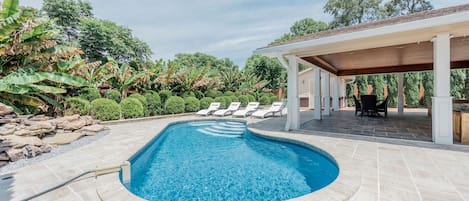 Gorgeous outdoor pool with pool chairs and relaxing patio space