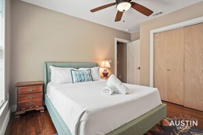 Queen bedroom with luxury hotel linens and private patio access