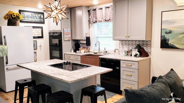 Bright, well-stocked full custom kitchen w/ stone counters & copper farm sink